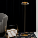 Lampadaire doré avec abat-jour en verre arrondi