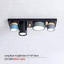 Plafonnier design avec plusieurs spots cylindriques colorés à LED