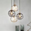 Suspension design à LED boule déformée en verre Head