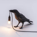 Applique murale LED avec oiseau qui tient une lampe dans son bec