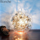 Lampe à poser boule en verre avec feuilles