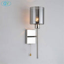 Applique murale design chromée à LED et abat-jour cylindrique en verre